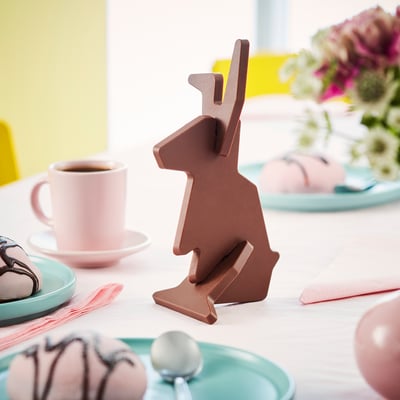 A chocolate bunny figure on easter-themed table setting.