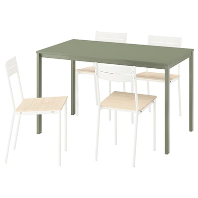 Green dining table with 4 white chairs, melamine top, metal legs. Chairs have wooden seats, metal legs, and two-slat backs.