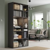 VIHALS black bookcase holds books & decor, tall & sleek in living room.