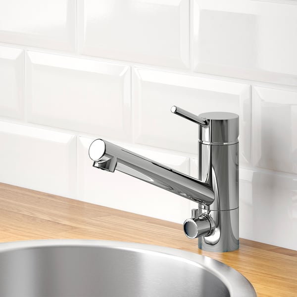 Modern chrome kitchen faucet with pull-out sprayer on wooden countertop, featuring water and energy-saving aerator.