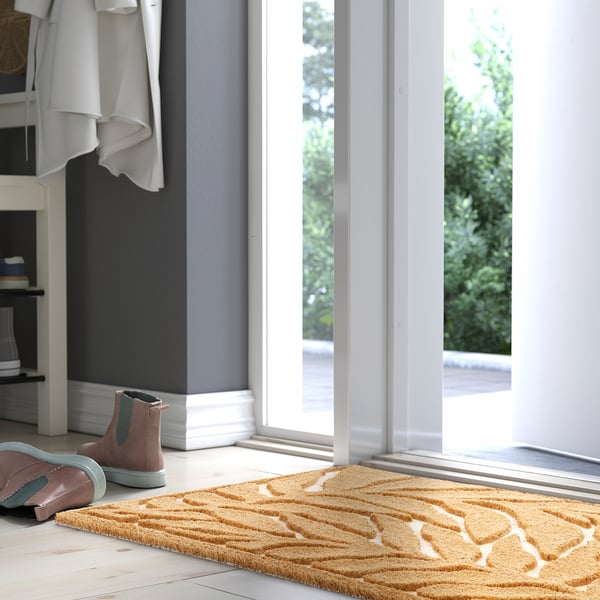 KONTANTER-ruskea kynnysmatto, jossa on valkoiset lehdet, tehokas likaa vastaan.