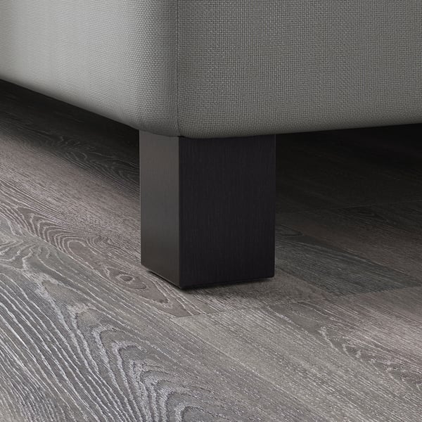 Närbild av moderna sängben i trä, slät finish, robust konstruktion i massivt trä.