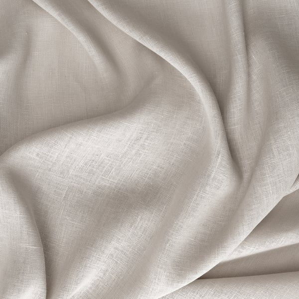 Mjukt, lätt strukturerat beige linnetyg, vikt och draperat, vilket gör att ljuset kan silas igenom.