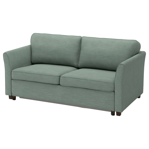Ljusgrön Ekholm-soffa, rektangulär, slank design, vadderad med träben.