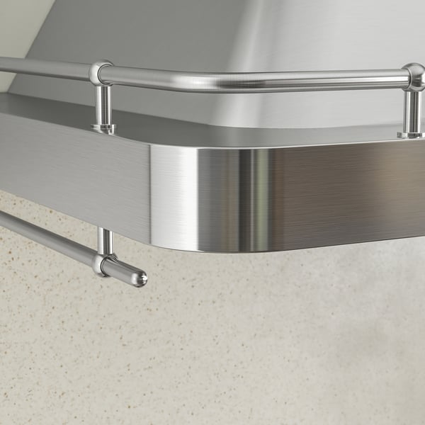 Huv i rostfritt stål med elegant design och polerad finish monterad på väggen. Rundade kanter och stödfästen i metall.