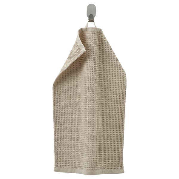 IKEA-handduken heter GULLDYNA, beige, rektangulär, hängande på en krok, texturerad.