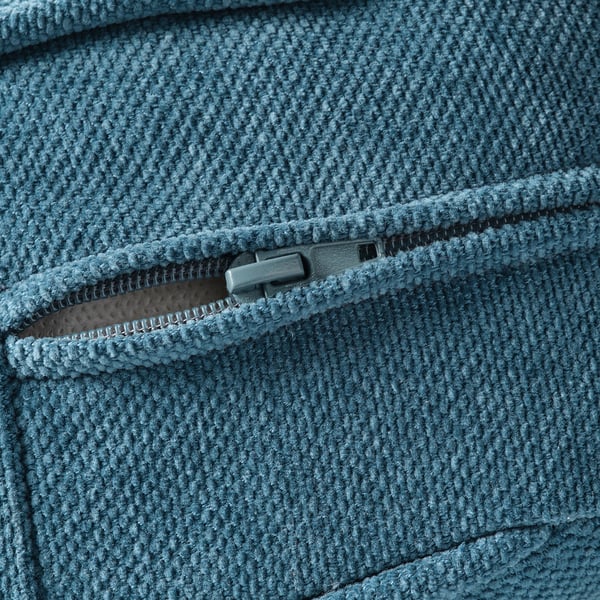 Närbild på en mjuk, texturerad blå soffdragkedja, som visar upp högkvalitativa sömmar och slitstarkt tyg.