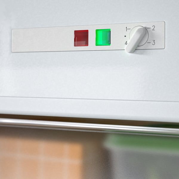 Kontrollpanel för integrerad frys med temperaturratt och LED-indikatorer.