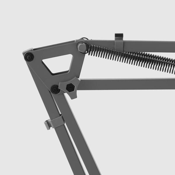 Bilden visar en robust mikrofonarm med dubbla fjädrar, redo för installation. Kvalitetsdesign för pålitlig användning.