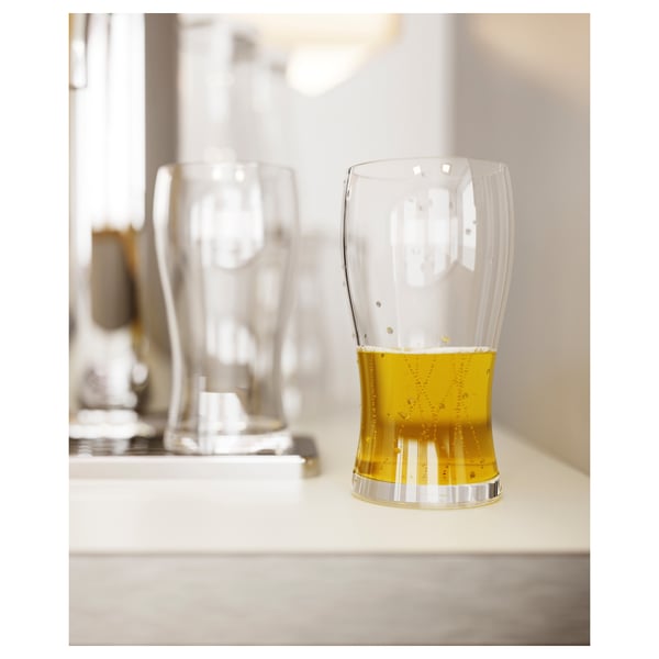 Produkt: LODRÄT ölglas. Klart glas, böjt, håller gyllene lager med skum.