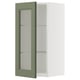 Väggskåp med grön glasdörr med vit insida.