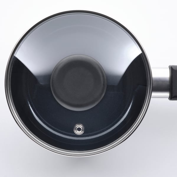 Ovanifrån av en modern kastrull med glaslock, som visar elegant design och kvalitetshantverk.