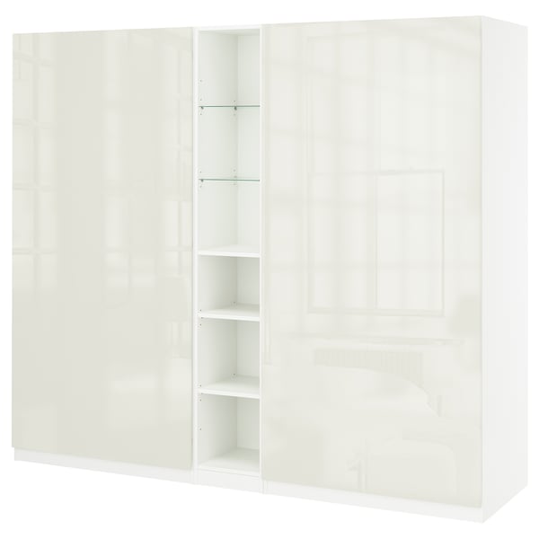 Vit PAX-garderob med flera dörrar, hyllor och lådor, elegant modern design, blank finish.