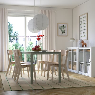 Matsal med mattan RIDSTIG, bord, stolar, skåp, fönster och lyktor.