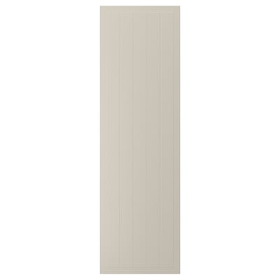 En beige STENSUND-skåpsdörr med vertikala spår och en slät, lackerad yta.