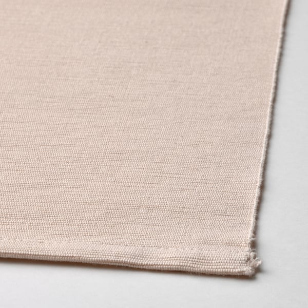 Närbild av vävd beige bordstablett; Naturlig bomullsstruktur av hög kvalitet synlig.