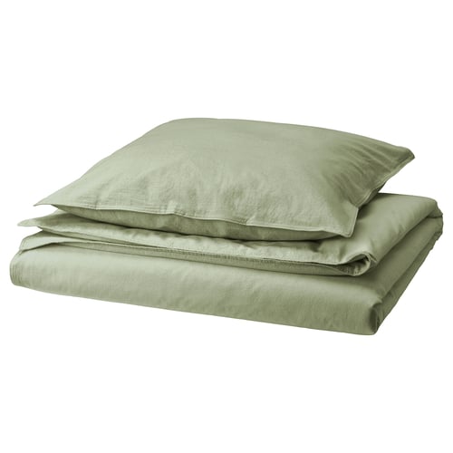 Ensemble couette et taie d’oreiller en coton vert, plié soigneusement, doux et respirant.