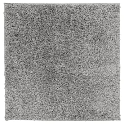 Un tapis carré gris ÄRENDE à la texture hirsute, en polypropylène et caoutchouc synthétique, idéal pour le confort et l’absorption acoustique.