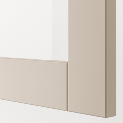 Un meuble de rangement ikea BESTÅ beige avec une porte vitrée. Le design rectangulaire comprend un cadre simple et élégant et un panneau de verre pour un look moderne.