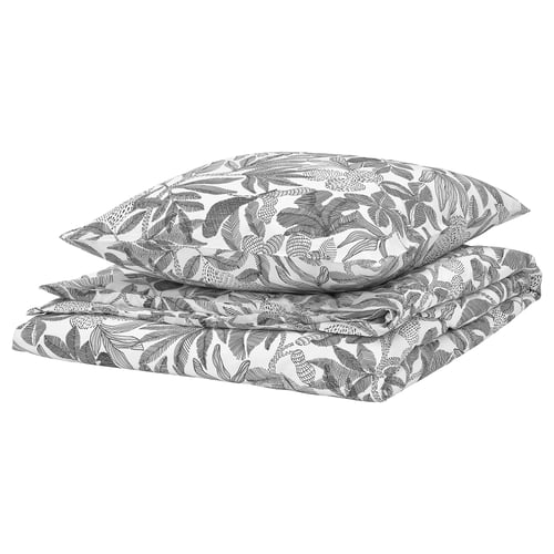 Ensemble de couette à feuilles noires et blanches, plié, mélange durable de polyester recyclé et de viscose.