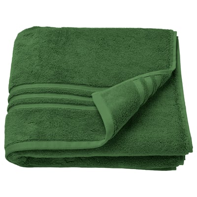 Serviette en coton biologique pliée vert foncé avec tissage dense et bordure décorative.