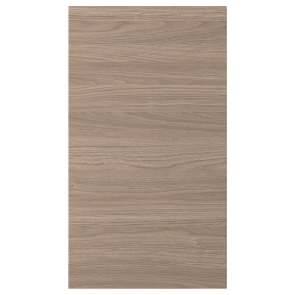 Une porte d’armoire de cuisine BROKHULT avec une texture de noyer naturel. Il a une forme rectangulaire avec des lignes simples et une surface lisse et facile à nettoyer.