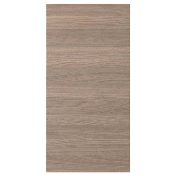 Une porte d’armoire de cuisine BROKHULT avec une surface à motif noyer brun clair, au design lisse et naturel.