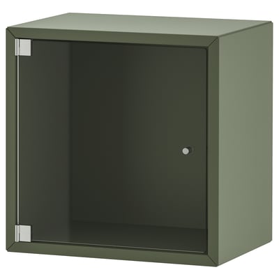 Représente une armoire de rangement EKET vert olive avec une porte en verre. Il s’agit d’une forme carrée avec un design moderne, avec des lignes épurées et un style minimaliste.