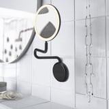 Miroir mural noir avec lumière et grossissement intégrés, idéal pour le maquillage ou le rasage.