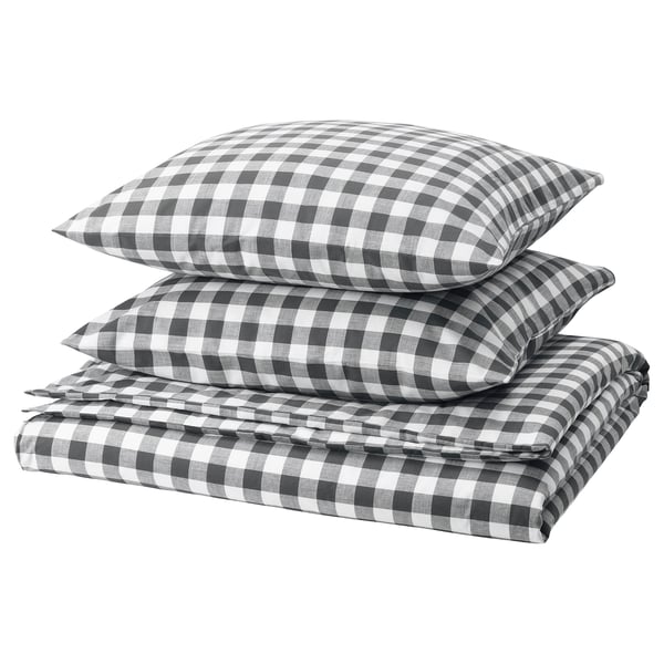 Parure de lit à carreaux noirs et blancs, soigneusement pliée. Fabriqué à partir de coton 100 % biologique.