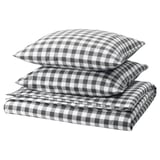 Parure de lit à carreaux noirs et blancs, soigneusement pliée. Fabriqué à partir de coton 100 % biologique.