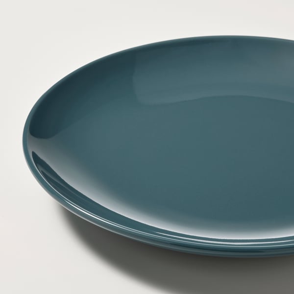 Plaque latérale lisse, ronde et bleue brillante avec un léger dégradé, mettant en valeur son design épuré.