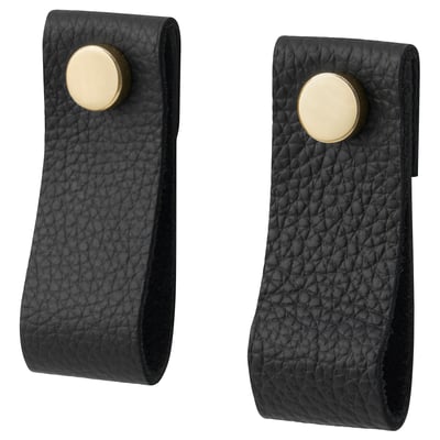 Poignées en cuir noir, fermetures circulaires dorées, design incurvé.