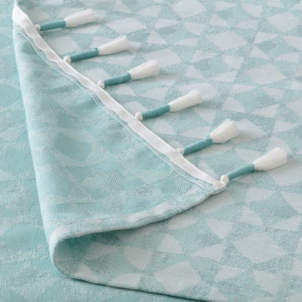 Jeté turquoise et blanc léger, doux et finement tissé avec des pompons faits à la main. Parfait pour le canapé ou le lit.