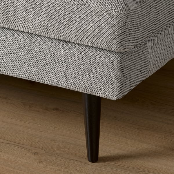 Canapé moderne avec des pieds en bois élégants, rembourré en tissu texturé, mettant en valeur un design de qualité et un confort.