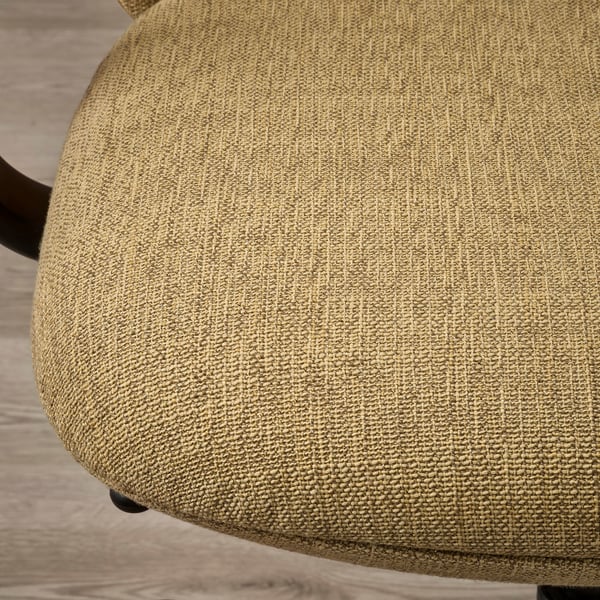 Siège circulaire d’une chaise en tissu doux et texturé, faisant probablement partie d’une chaise de bureau ergonomique.