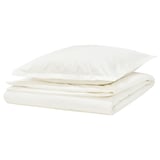 Un ensemble de housse de couette HAMPFLOCKEL blanc en 100 % coton avec un tissage en percale impeccable, avec des taies d’oreiller de style enveloppe et des brides décoratives.