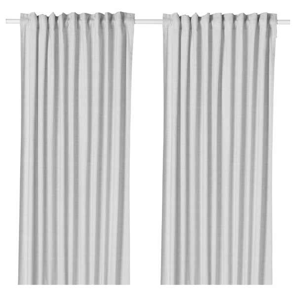 Les rideaux blancs HANNALILL, fabriqués à 100 % en coton, présentent un design simple et élégant avec des passe-tringles pour une suspension facile, offrant intimité et contrôle de la lumière.