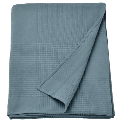 Couvre-lit INDIRA en coton bleu, texturé, plié, pour lits doubles.