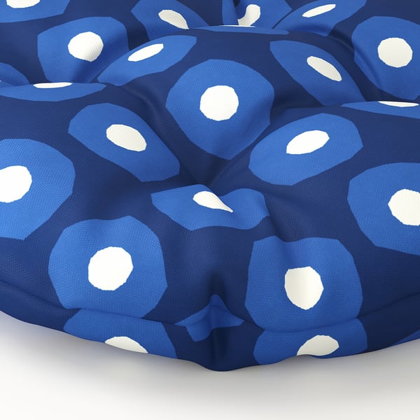 Coussin circulaire bleu avec des motifs blancs. Tissu doux en polyester recyclé, confortable et écologique.