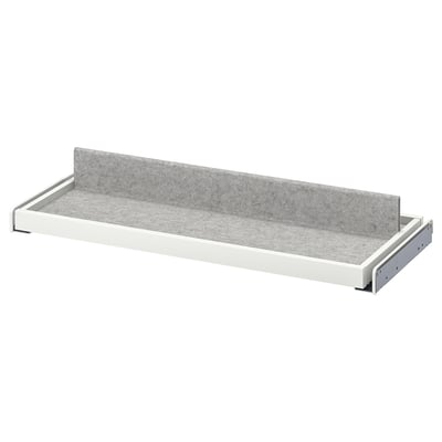 Un plateau coulissant KOMPLEMENT blanc avec doublure en feutre gris, conçu pour organiser les articles de garde-robe.