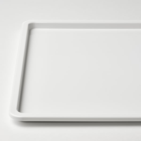 Plateau rectangulaire propre, blanc avec des bords lisses, posé à plat sur une surface.