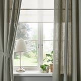 Fenêtre avec rideaux LENDA, lampe, plante sur rebord.