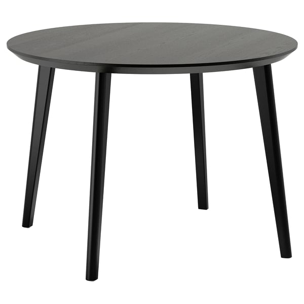 Table à manger ronde noire moderne, quatre pieds en bois inclinés, design minimaliste.