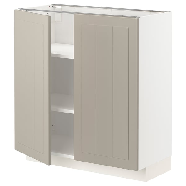 Une armoire METOD beige avec deux portes s’ouvre, révélant des étagères à l’intérieur.
