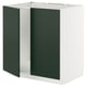 Armoire METOD blanche avec portes en panneaux de fibres acryliques vert foncé.