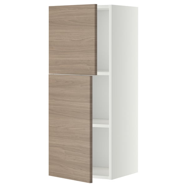 Une armoire murale METOD blanche avec deux portes en bois marron clair et des étagères réglables.