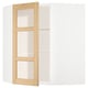 Une armoire de cuisine METOD blanche avec des garnitures en chêne et des portes en verre.