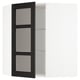 Une armoire en bois teinté noir avec des portes en verre et des étagères réglables.