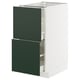 Armoire de cuisine blanche moderne avec deux tiroirs verts, design élégant.